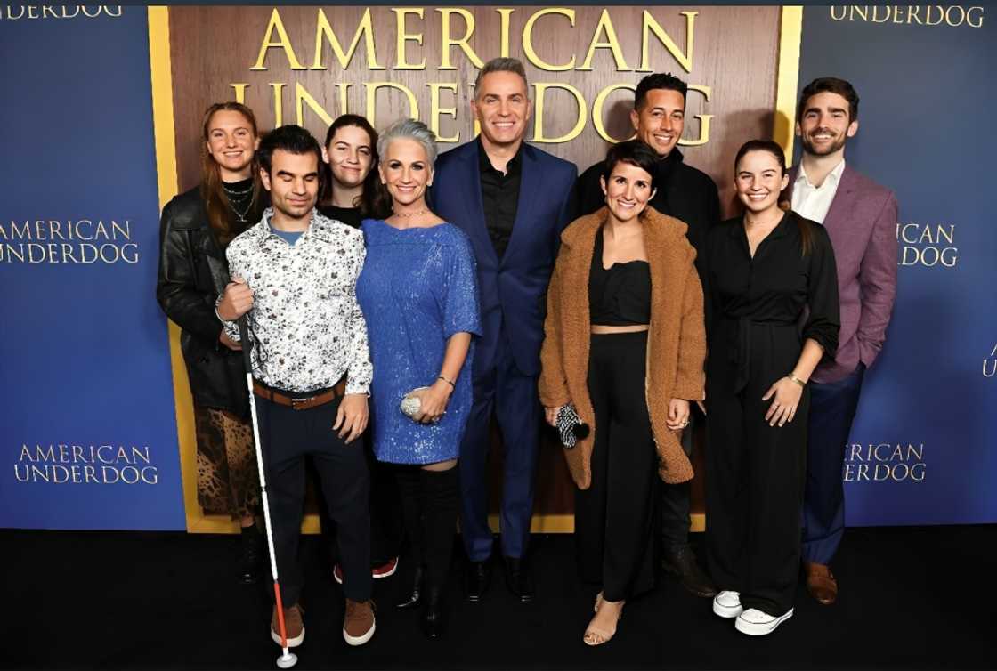 Kurt Warner's family takes a family picture at at an event Kurt Warner's family takes a family picture at at an event