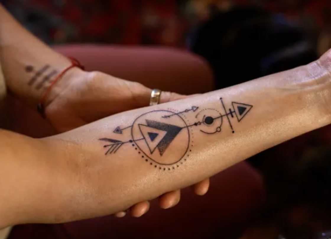 Geometric arrow tattoo