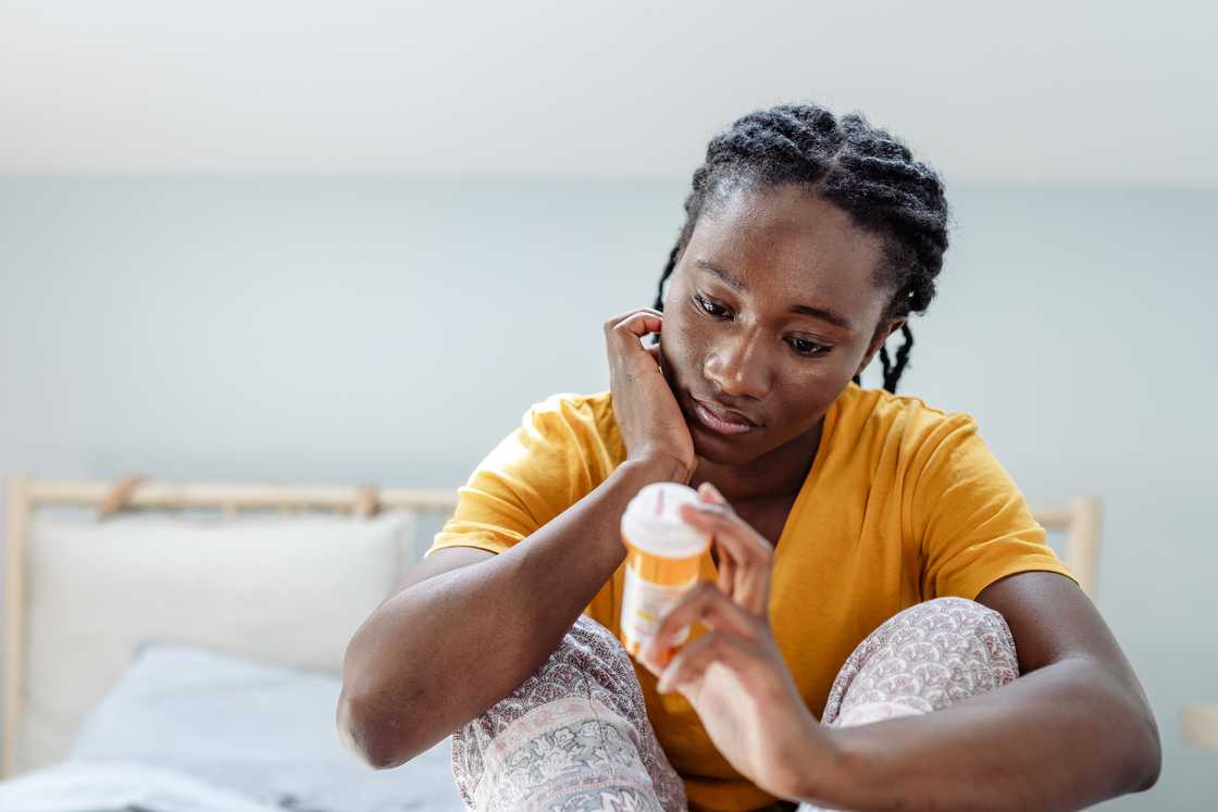 A lady holds her medicine A lady holds her medicine
