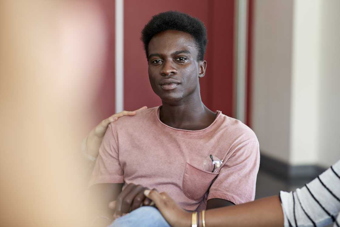 A man shares his story with a group of survivors
