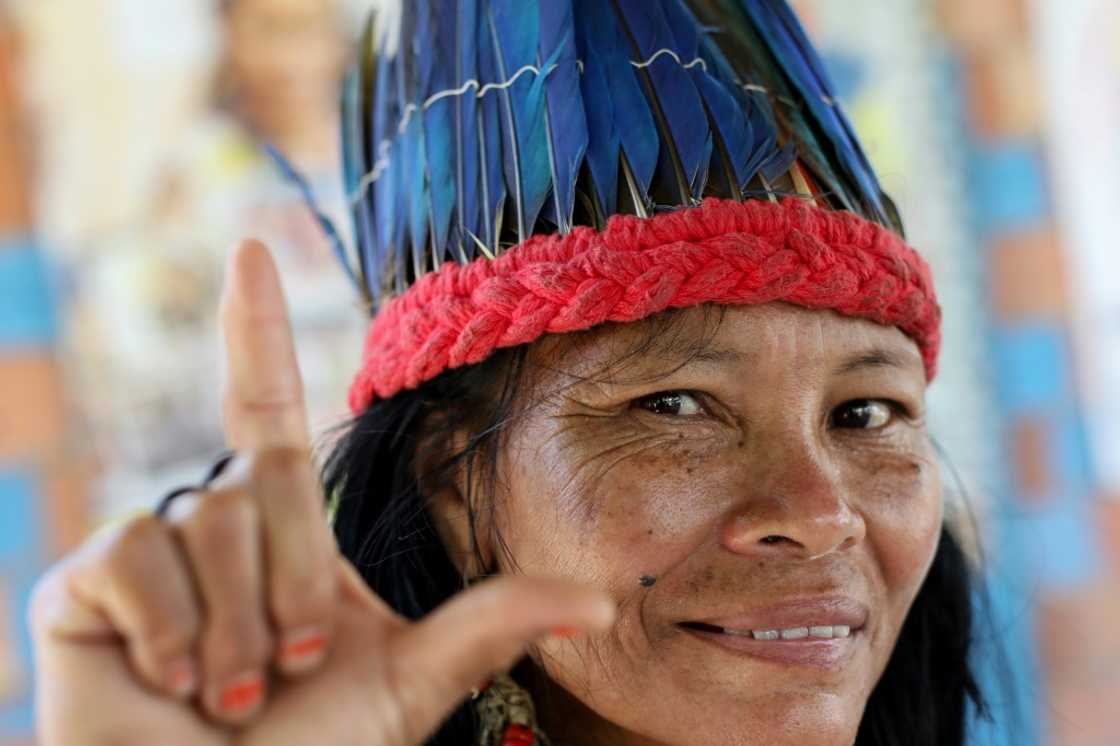 Lutana Ribeiro, from Brazil's Kokama tribe, flashes the "L" sign in support of leftist presidential candidate Luiz Inacio Lula da Silva on October 27, 2022 Lutana Ribeiro, from Brazil's Kokama tribe, flashes the "L" sign in support of leftist presidential candidate Luiz Inacio Lula da Silva on October 27, 2022
