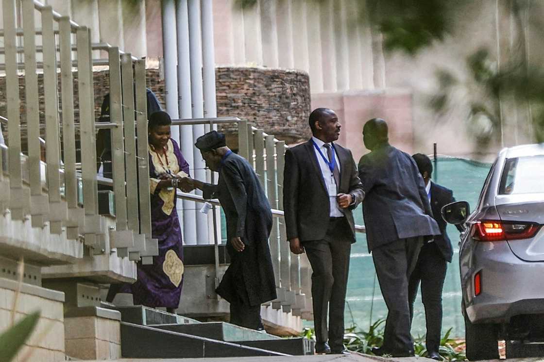 African Union envoy Olusegun Obasanjo, wearing a cap, is leading the talks