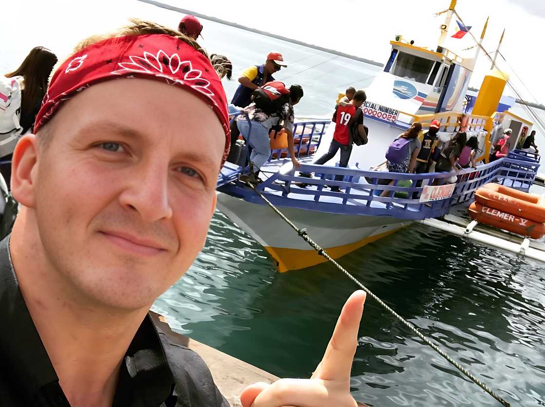 Will Sonbuchner takes a selfie at a dock with a Philippine passenger boat. Will Sonbuchner takes a selfie at a dock with a Philippine passenger boat.