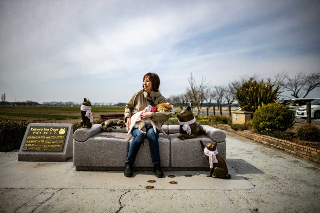 Atsuko Sato sits with her Japanese shiba inu dog Kabosu, best known as the face of the cryptocurrency Dogecoin