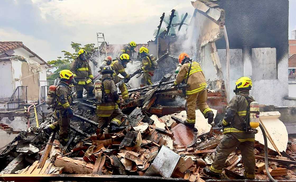 Firefighters work at the site where a light aircraft crashed, leaving eight people dead in the Belen Rosales neighborhood in Medellin, Colombia Firefighters work at the site where a light aircraft crashed, leaving eight people dead in the Belen Rosales neighborhood in Medellin, Colombia