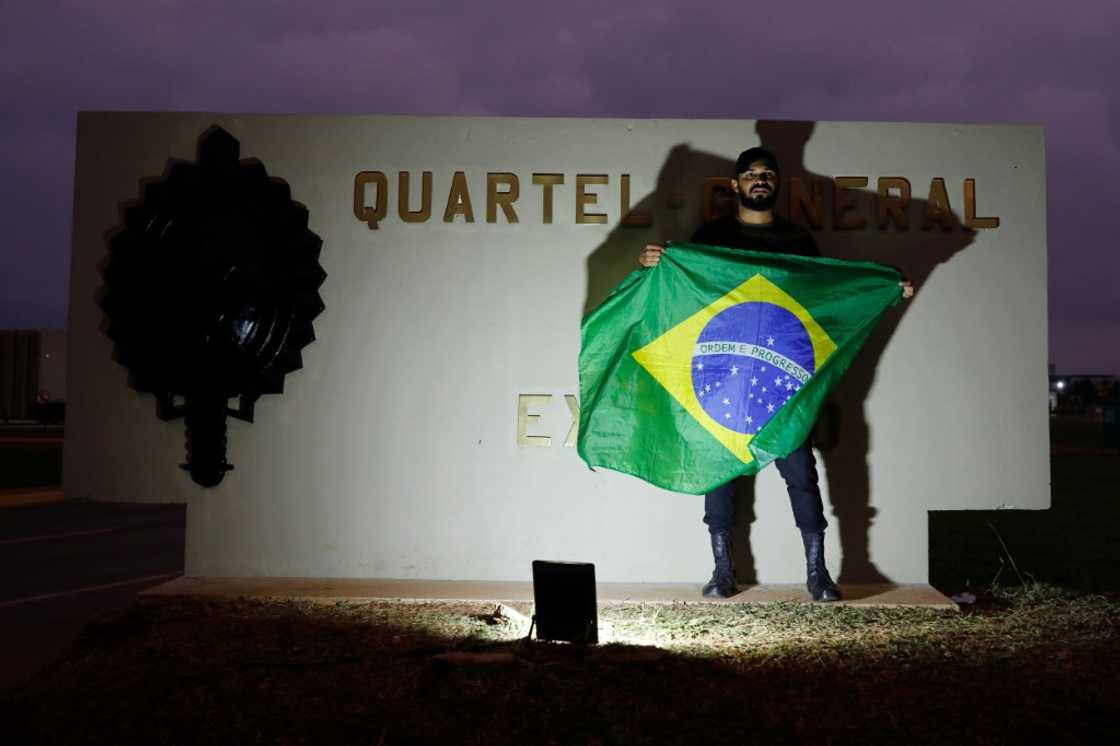 A lone supporter of President Jair Bolsonaro, who lost a bid for re-election, stands outside army headquarters in Brasilia on November 2, 2022