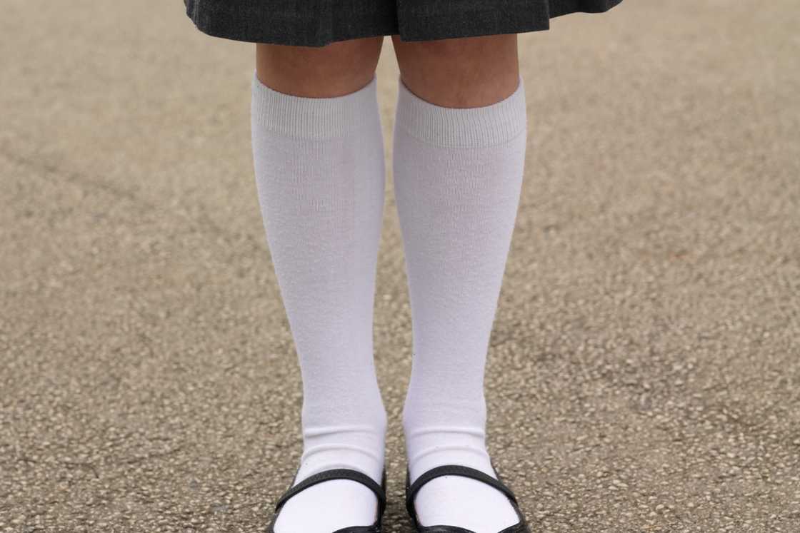 A school girl with knee-high white socks A school girl with knee-high white socks