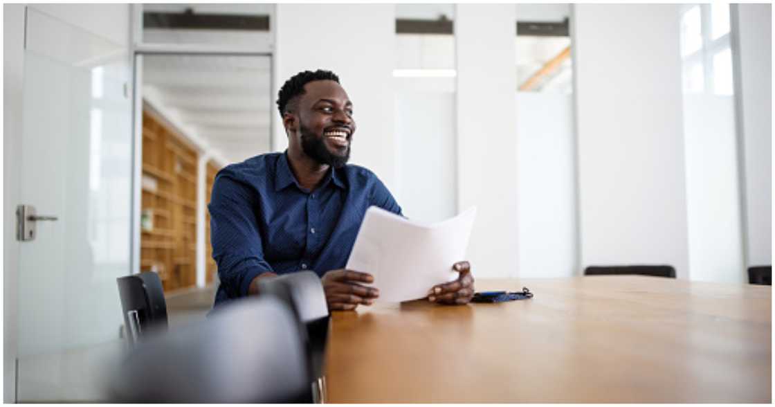 A man smiling in his new office space A man smiling in his new office space