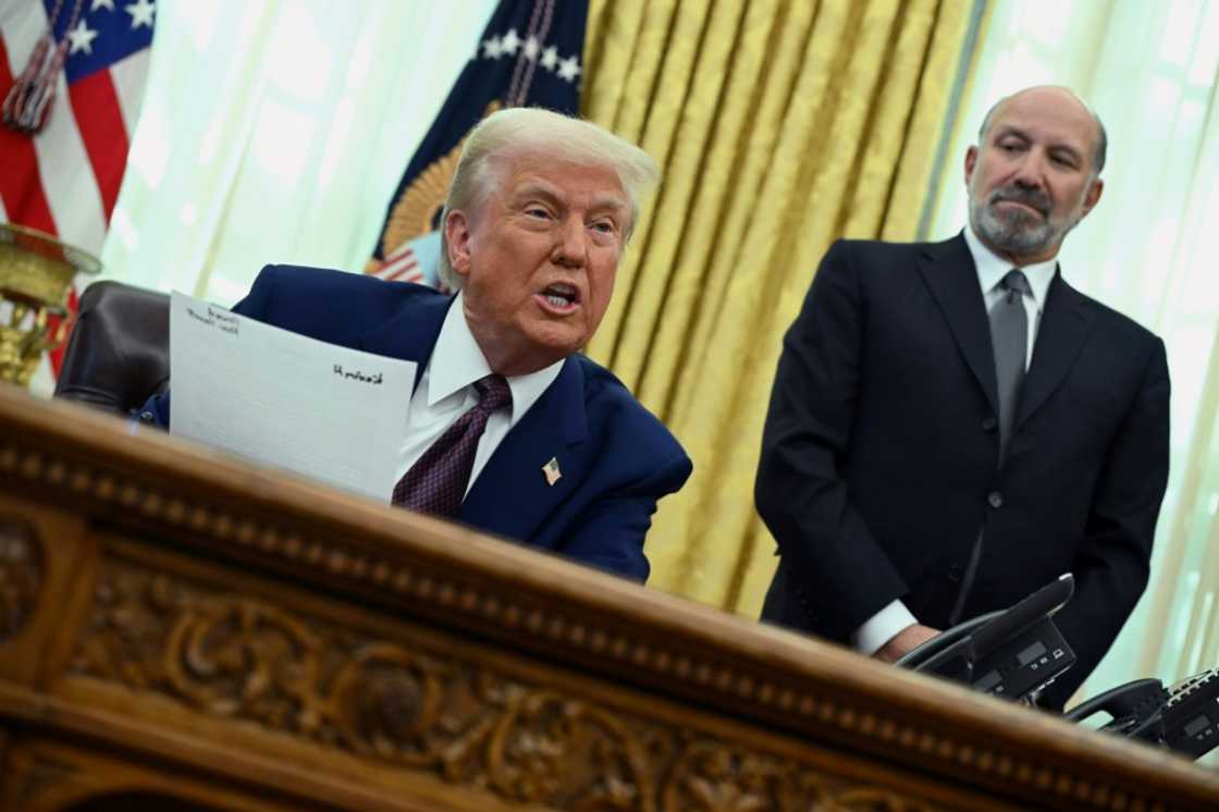 US President Donald Trump announces reciprocal tariffs from the White House Oval Office on February 13, 2025 as Howard Lutnick looks on US President Donald Trump announces reciprocal tariffs from the White House Oval Office on February 13, 2025 as Howard Lutnick looks on