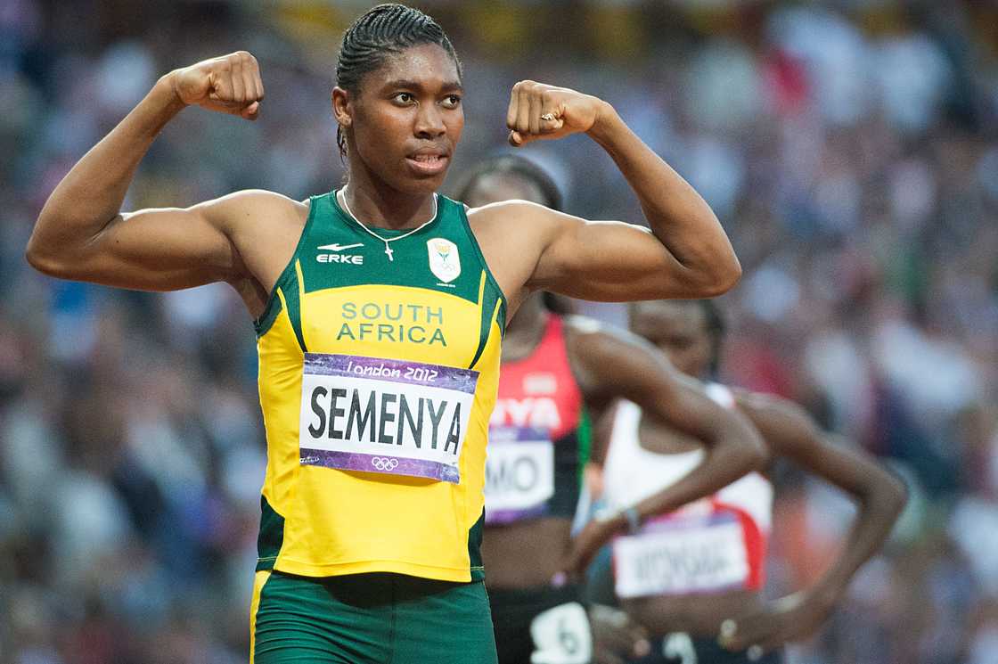 Caster Semenya of South Africa flexes her muscles after winning the silver medal in the women's 800-meters at the Summer Olympics in London