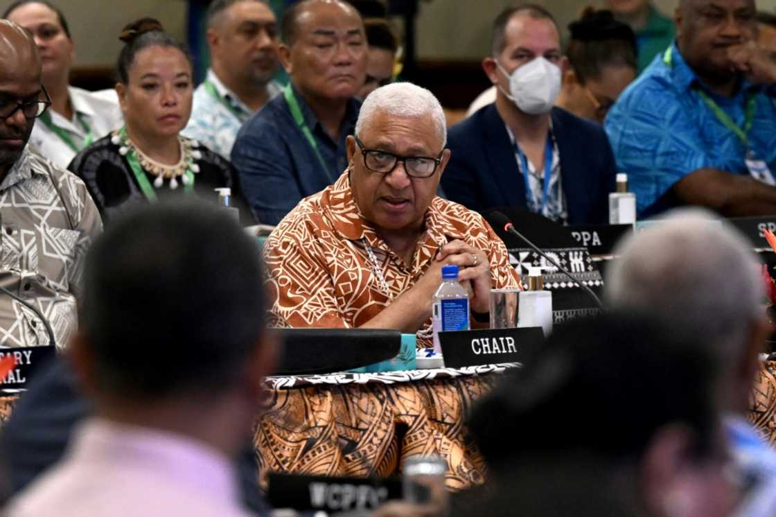 Fijian Prime Minister Frank Bainimarama (C), pictured on July 12, 2022 at the Pacific Islands Forum in Suva, before the arrest of his son in Australia