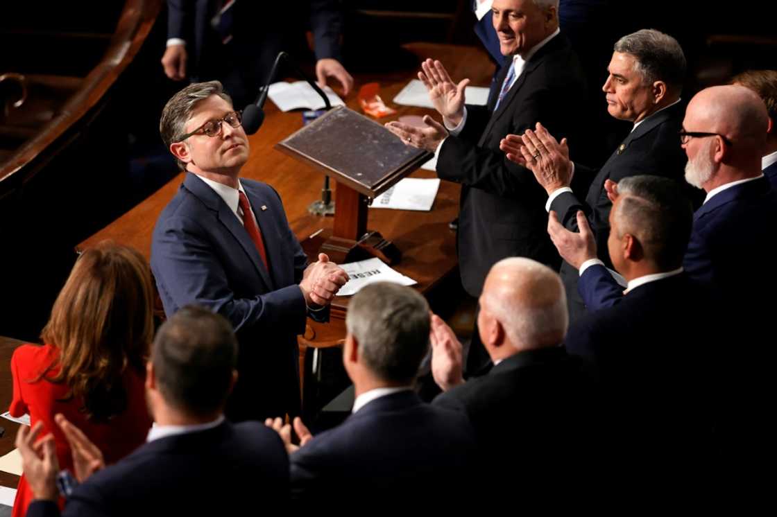 Mike Johnson, seen receiving applause after being re-elected speaker of the US House of Representatives, says he hopes for speedy passage of a massive bill full of Donald Trump's priorities