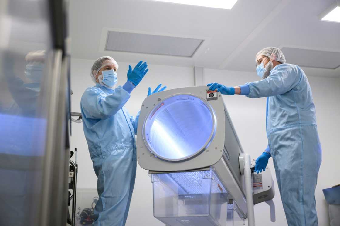 Staff show a specialized device for processing the raw cannabis flowers Staff show a specialized device for processing the raw cannabis flowers