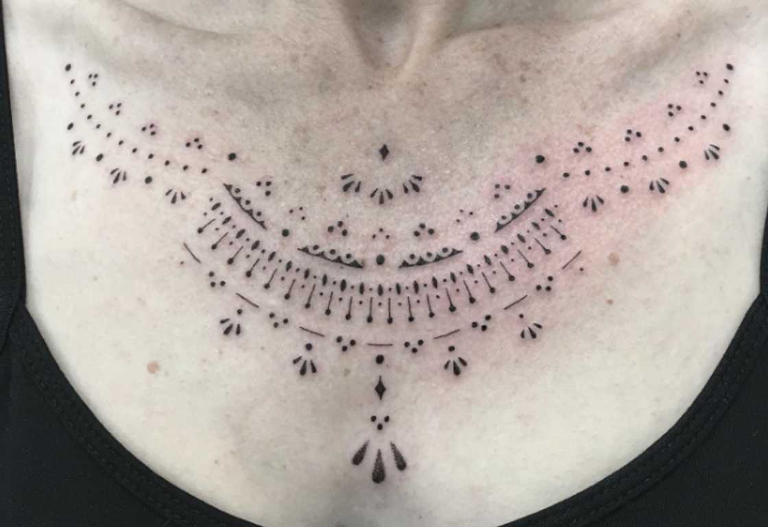 Tassel and lace ornamental collarbone tattoo for women