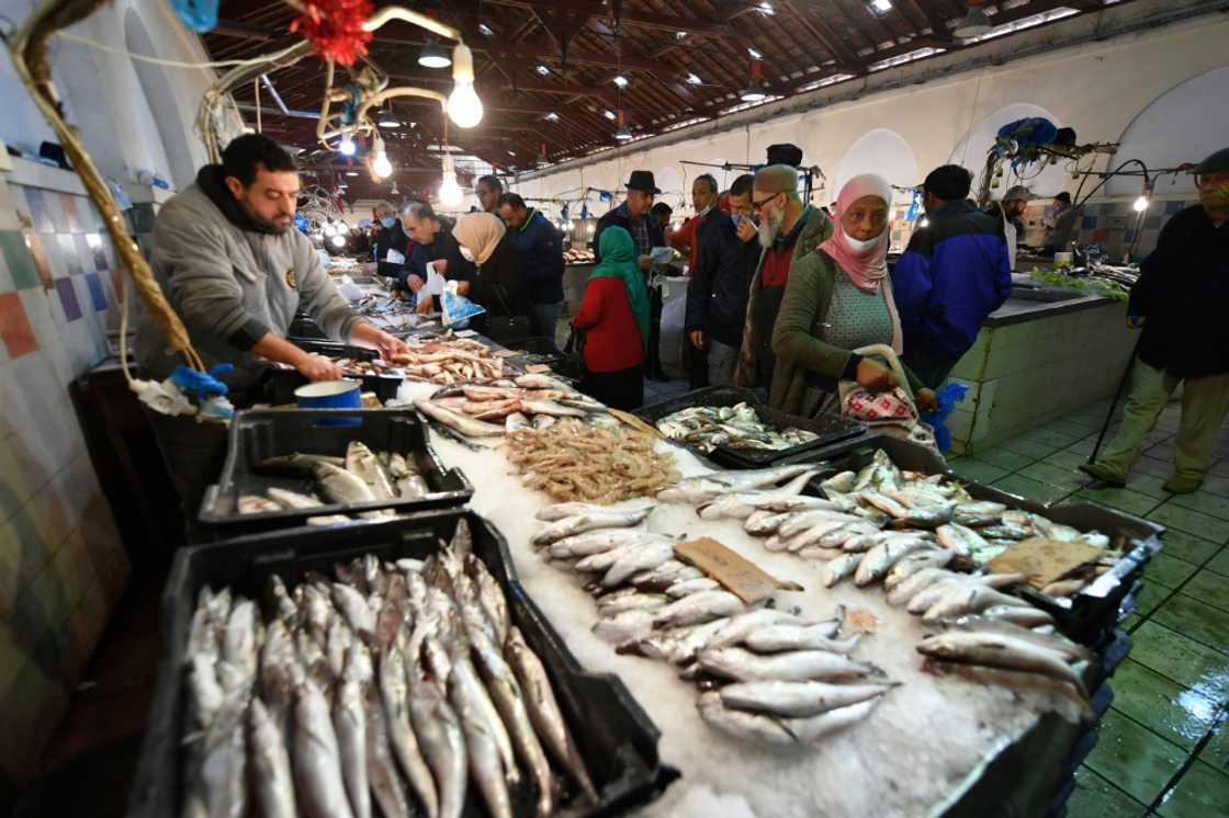 Tunisians shop at a fish market in the capital Tunis -- fish is a staple of Tunisian cuisine and a major export