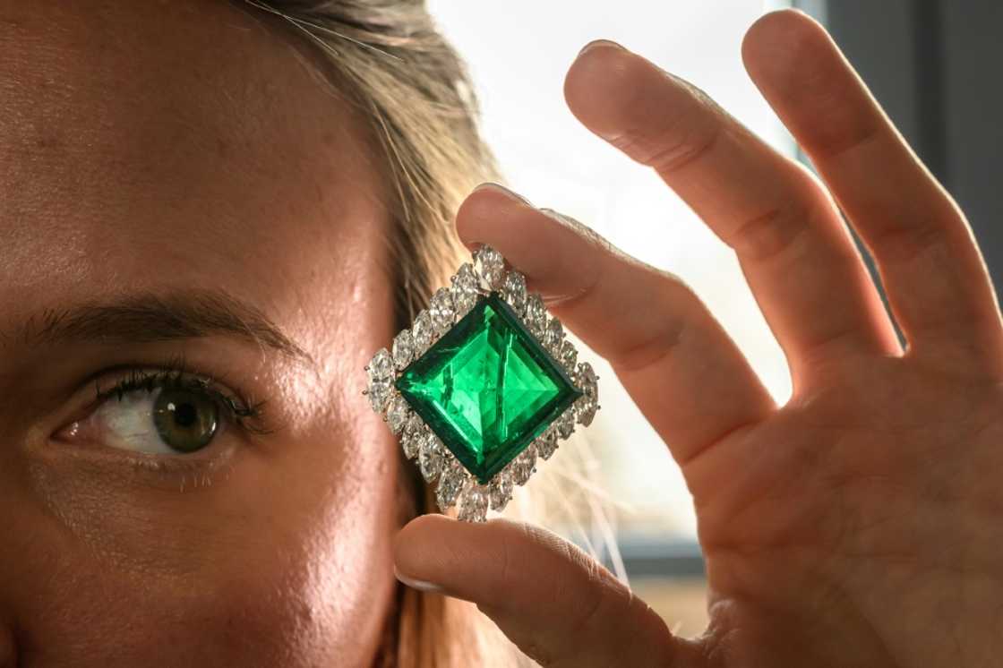 A Christie's employee poses with The Aga Khan Emerald A Christie's employee poses with The Aga Khan Emerald