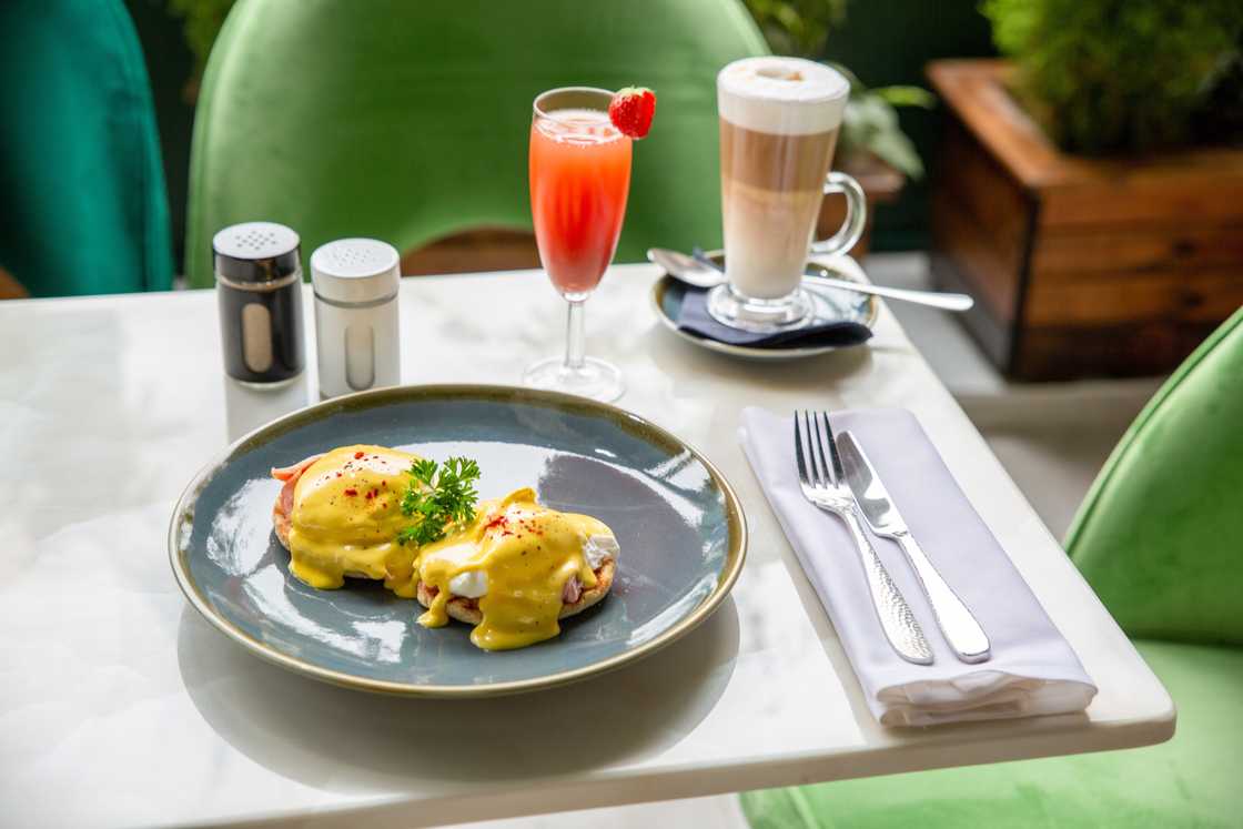 Eggs Benedict served with coffee and juice Eggs Benedict served with coffee and juice