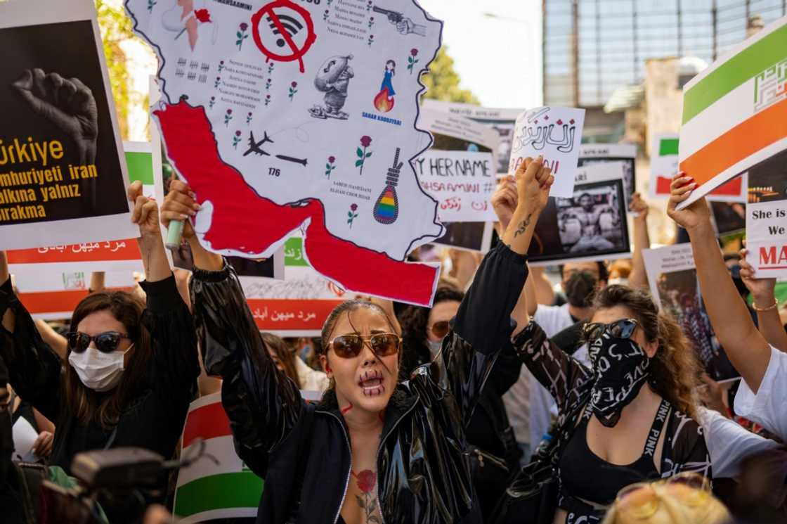 Protesters hold banners as they take part in a rally outside the Iranian consulate in Istanbul on September 29, 2022 Protesters hold banners as they take part in a rally outside the Iranian consulate in Istanbul on September 29, 2022