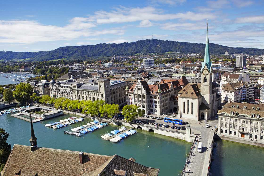 The skyline of Zurich with Fraumunster church, River Limmat and Lake Zurich from Grossmunster church.