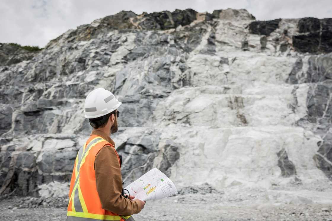 This handout picture provided by Sayona Quebec shows an employee in front of a lithium deposit at the company's lithium complex in La Corne, Quebec This handout picture provided by Sayona Quebec shows an employee in front of a lithium deposit at the company's lithium complex in La Corne, Quebec