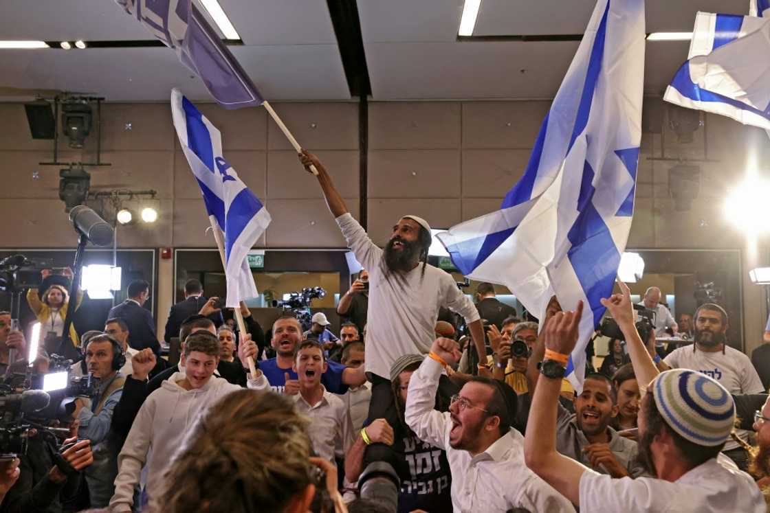 Supporters of Israel's Otzma Yehudit (Jewish Power) far-right party cheer at campaign headquarters after the end of voting on Tuesday Supporters of Israel's Otzma Yehudit (Jewish Power) far-right party cheer at campaign headquarters after the end of voting on Tuesday