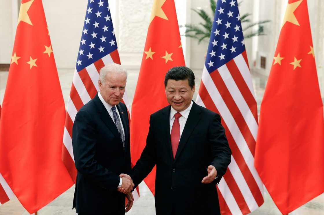 Chinese President Xi Jinping shakes hands with then US vice president Joe Biden inside the Great Hall of the People in Beijing on December 4, 2013 Chinese President Xi Jinping shakes hands with then US vice president Joe Biden inside the Great Hall of the People in Beijing on December 4, 2013