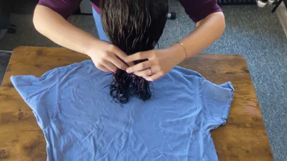 A woman positing her hair on a cotton T-shirt