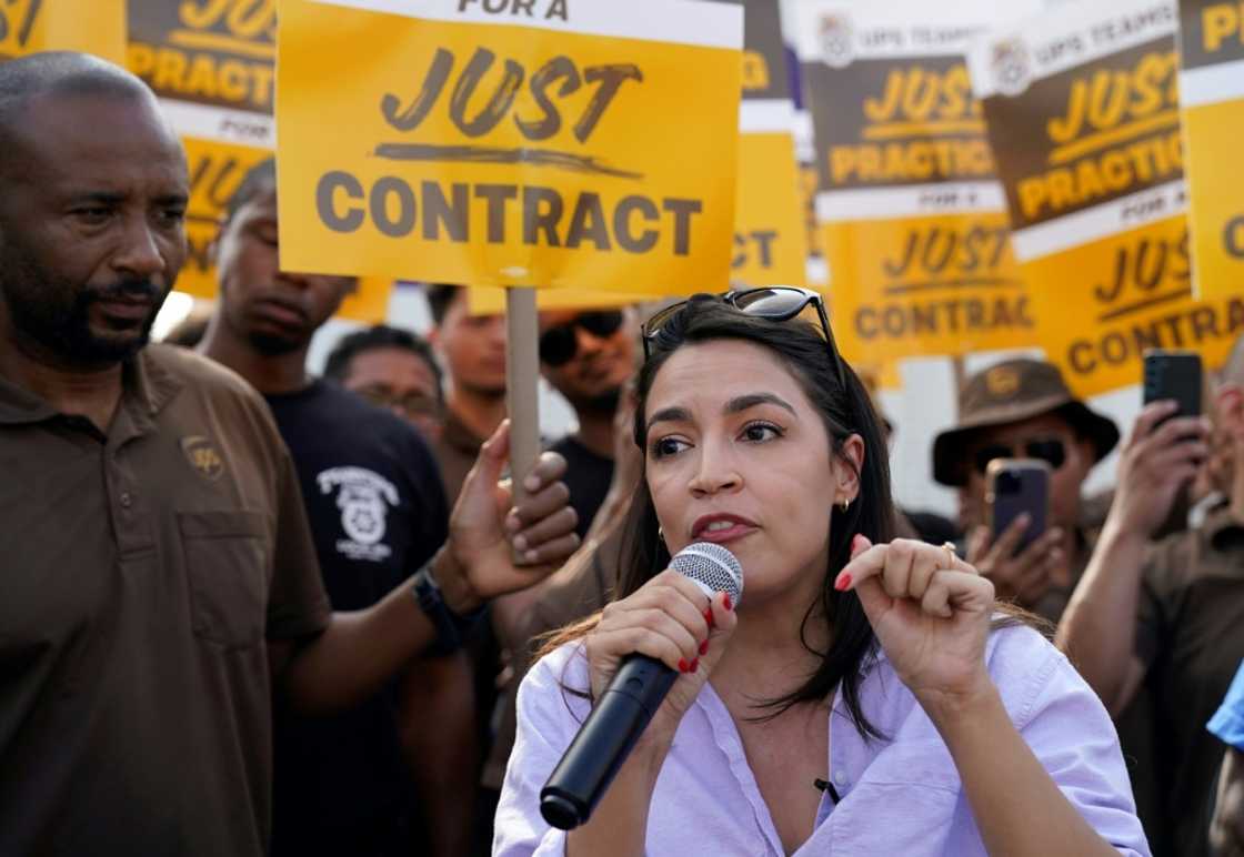 US Representative Alexandria Ocasio-Cortez, Democrat of New York, speaks to United Parcel Services (UPS) workers during a 'practice picket line' on July 7, 2023, in the Queens borough of New York City, ahead of a possible UPS strike US Representative Alexandria Ocasio-Cortez, Democrat of New York, speaks to United Parcel Services (UPS) workers during a 'practice picket line' on July 7, 2023, in the Queens borough of New York City, ahead of a possible UPS strike