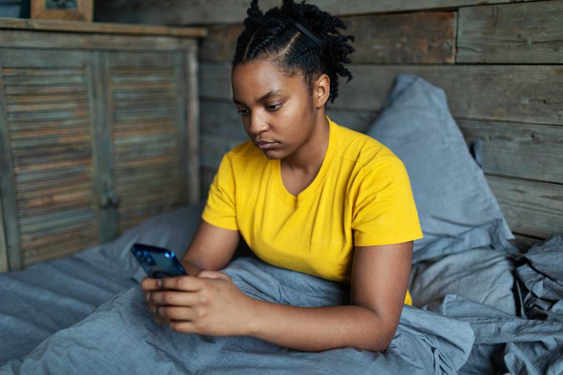 A sad lady is using her phone A sad lady is using her phone