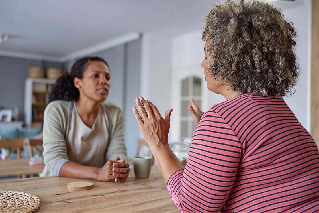 A sad woman refuses her friend's help