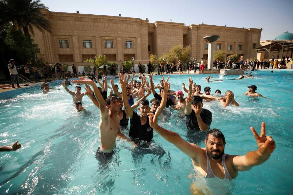 Sadr supporters swim in the pool of the government headquarters on August 29 Sadr supporters swim in the pool of the government headquarters on August 29