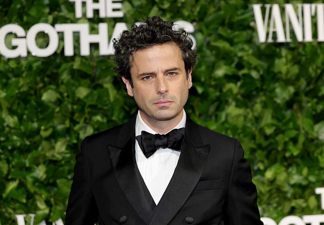 Luke Kirby in a black suit and white shirt Luke Kirby in a black suit and white shirt