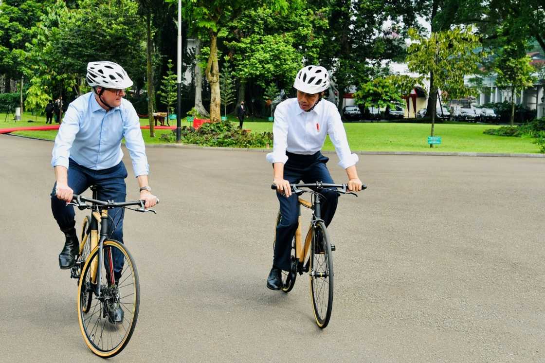 Indonesian President Joko Widodo (R) presented new  Australian Prime Minister Anthony Albanese with a bamboo bike