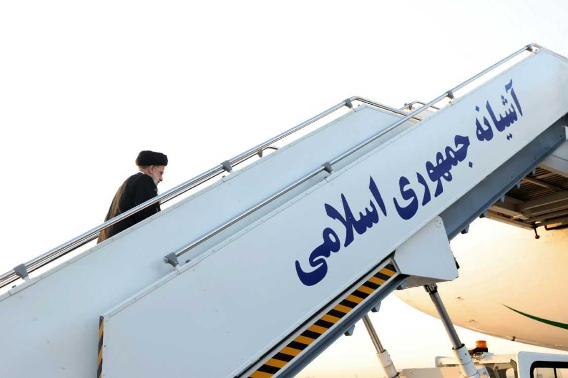 Iran's President Ebrahim Raisi climbs the stairs to his aircraft before departure from the capital Tehran's Mehrabad International Airport en route to the United Nations General Assembly