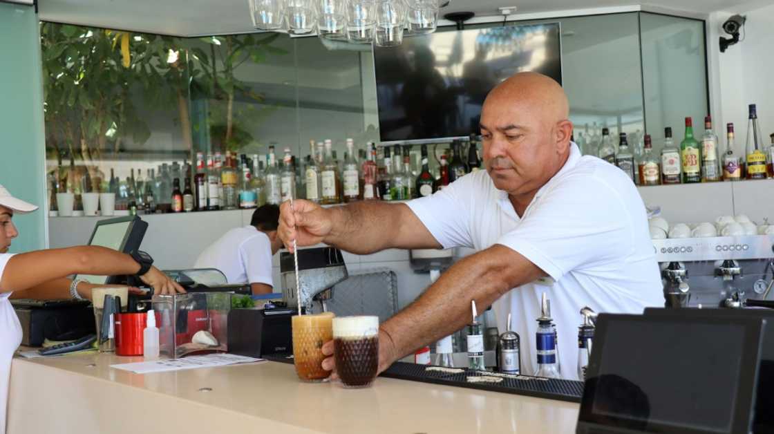 A bartender works at the Alion Beach Hotel in the Cypriot resort town of Ayia Napa. Operators had hoped this summer would see Russian tourist numbers return to pre-pandemic levels