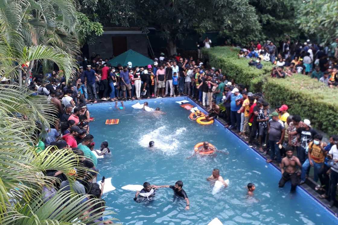 Some protesters initially enjoyed a dip in the presidential pool after storming the residence Some protesters initially enjoyed a dip in the presidential pool after storming the residence