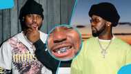 King Promise rocks new silver grillz on his teeth, flaunts them in video