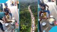 Road users cook and eat their new year meal on the Accra-Kumasi highway due to heavy traffic