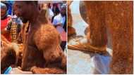 Ghanaian man showcases the clothes, slippers and bag he made from wood