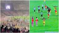Black Stars players run as angry Nigerian fans invade the pitch in Abuja, tear gas fired in video
