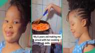 Little girl prepares delicious food in kitchen, her mum watches with admiration: "You will enjoy it"