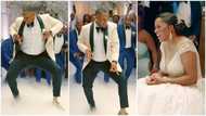 Handsome groom bends down low, uses his waist to dance like a lady, excited guests gather to watch in video