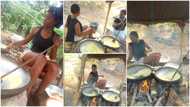 Beautiful lady who fries yellow garri for a living proudly flaunts her in photos