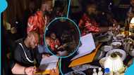 Davido sits at dinner table with King Promise, refuses to eat food served him