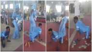 Cash rains as paraplegic man dance-crawls with wife to the altar for their child dedication in new video