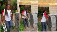 54-year-old Portuguese Ghanaian farmer carries his own blocks to build his house