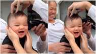Funny video emerges as baby keeps laughing as barber gives him haircut