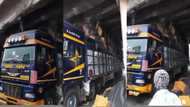 Video pops up as overloaded truck gets stuck under Achimota overheard; Ghanaians 'bore'