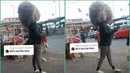 Lady storms main road with a crazy afro hairstyle, video trends