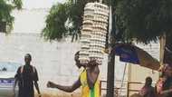 Man Walks on Wet Ground While Carrying Loads of Eggs on One Arm